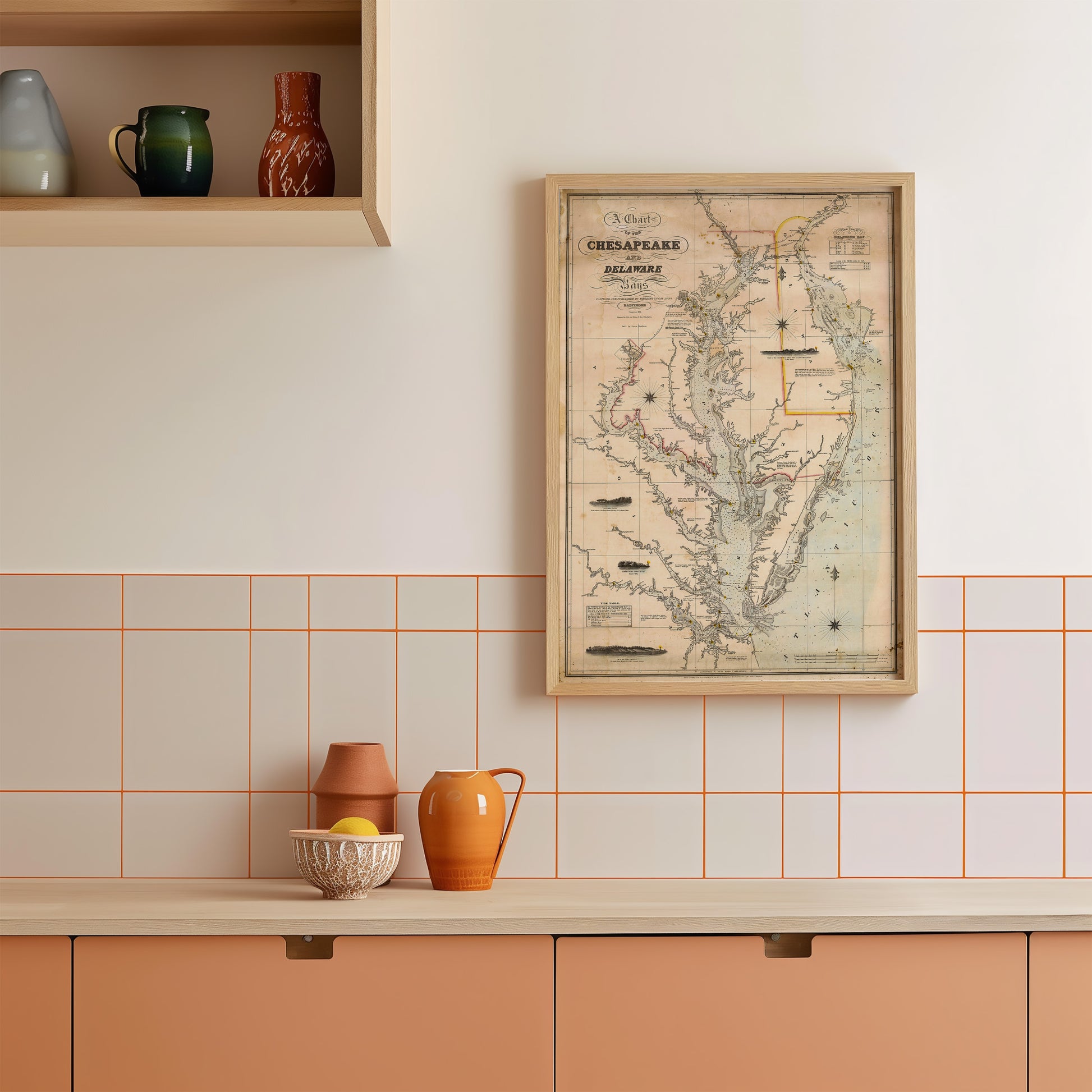 a kitchen counter with various items on it, including a map of the Chesapeake Bay region, a bowl, a pitcher, and a vase.