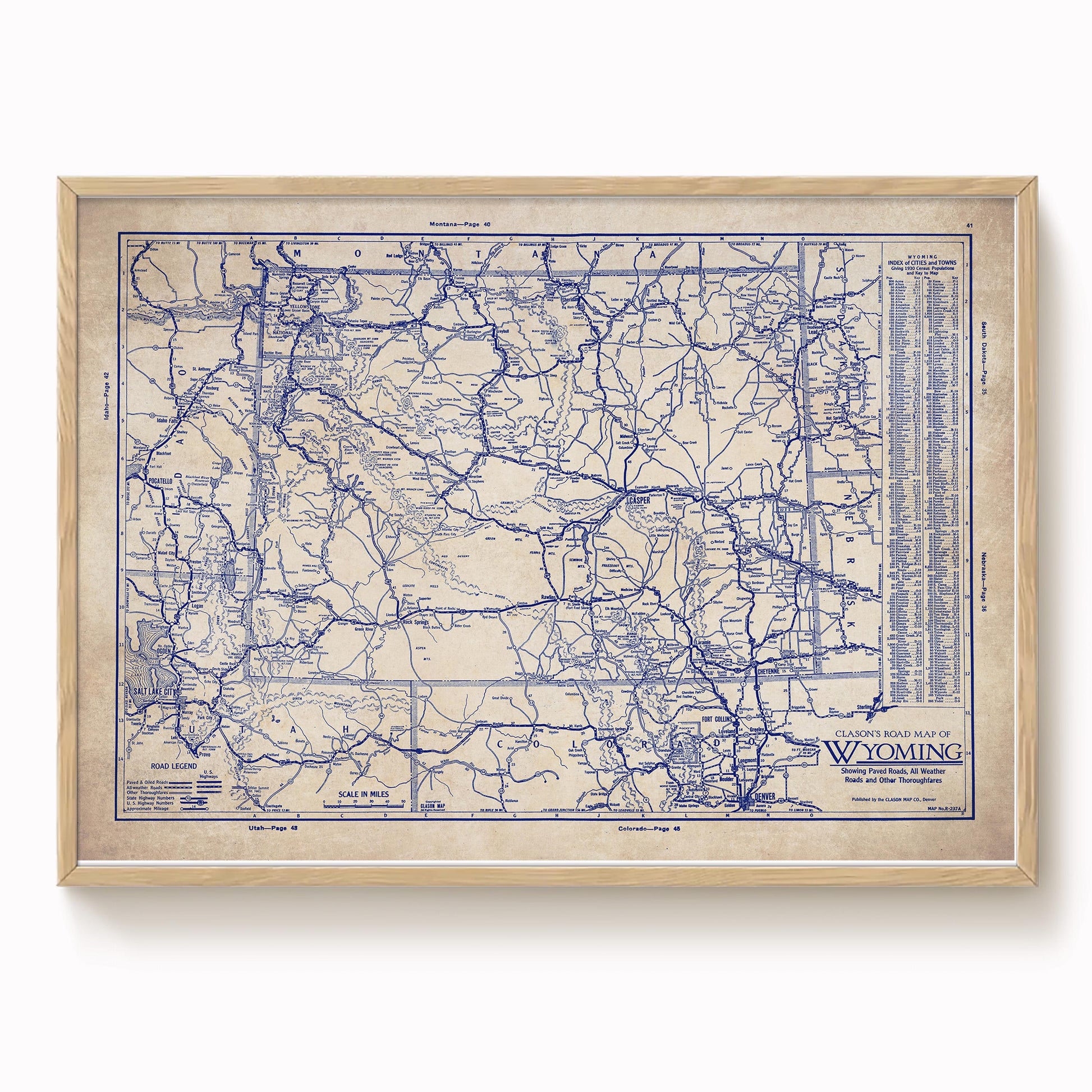 The image is a framed vintage map of Wyoming, depicting the state's roads and highways in a detailed and intricate manner.