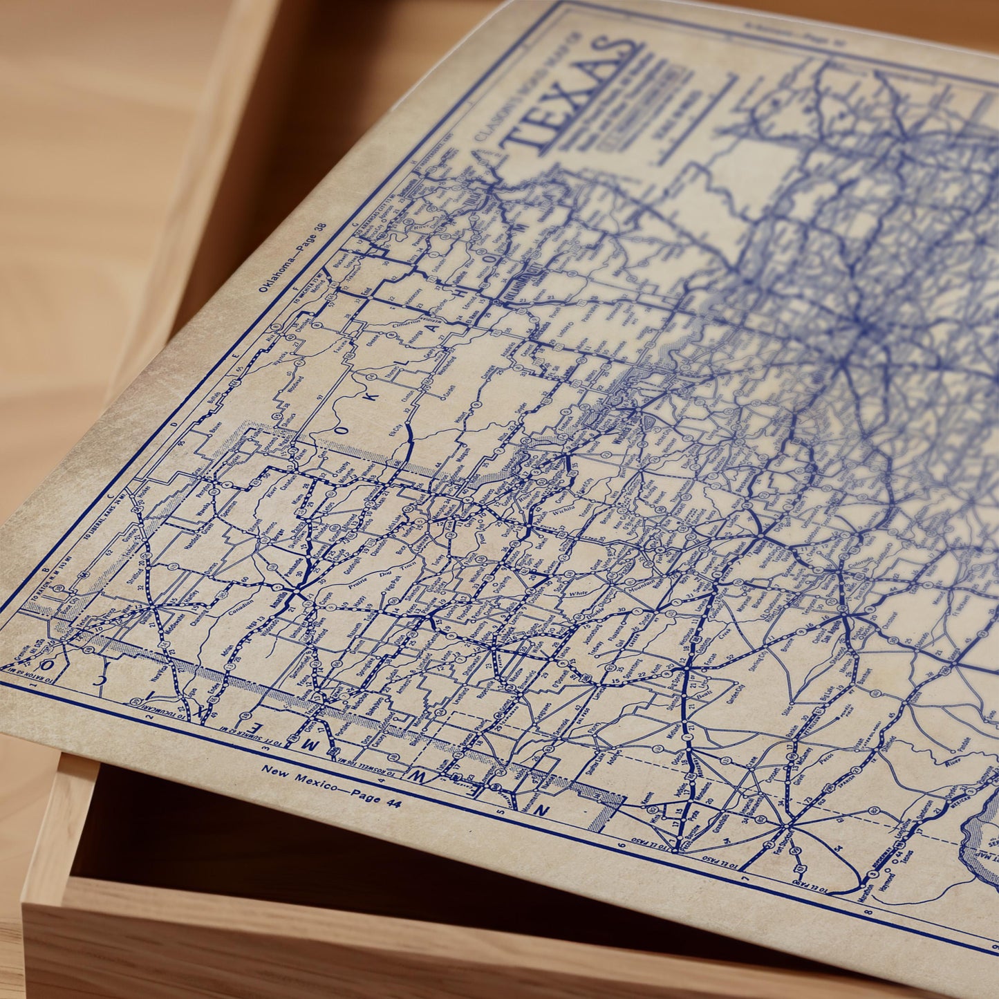a close-up view of a map of Texas, with the map's title "Texas" visible. The map appears to be an old or vintage style, with a blue and white color scheme.