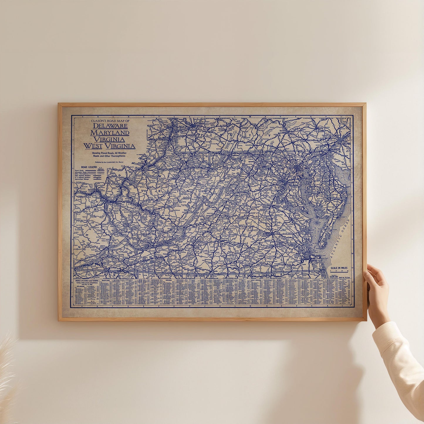 A framed map of the eastern United States, specifically the eastern United States and parts of Virginia, is being held by a person's hand.