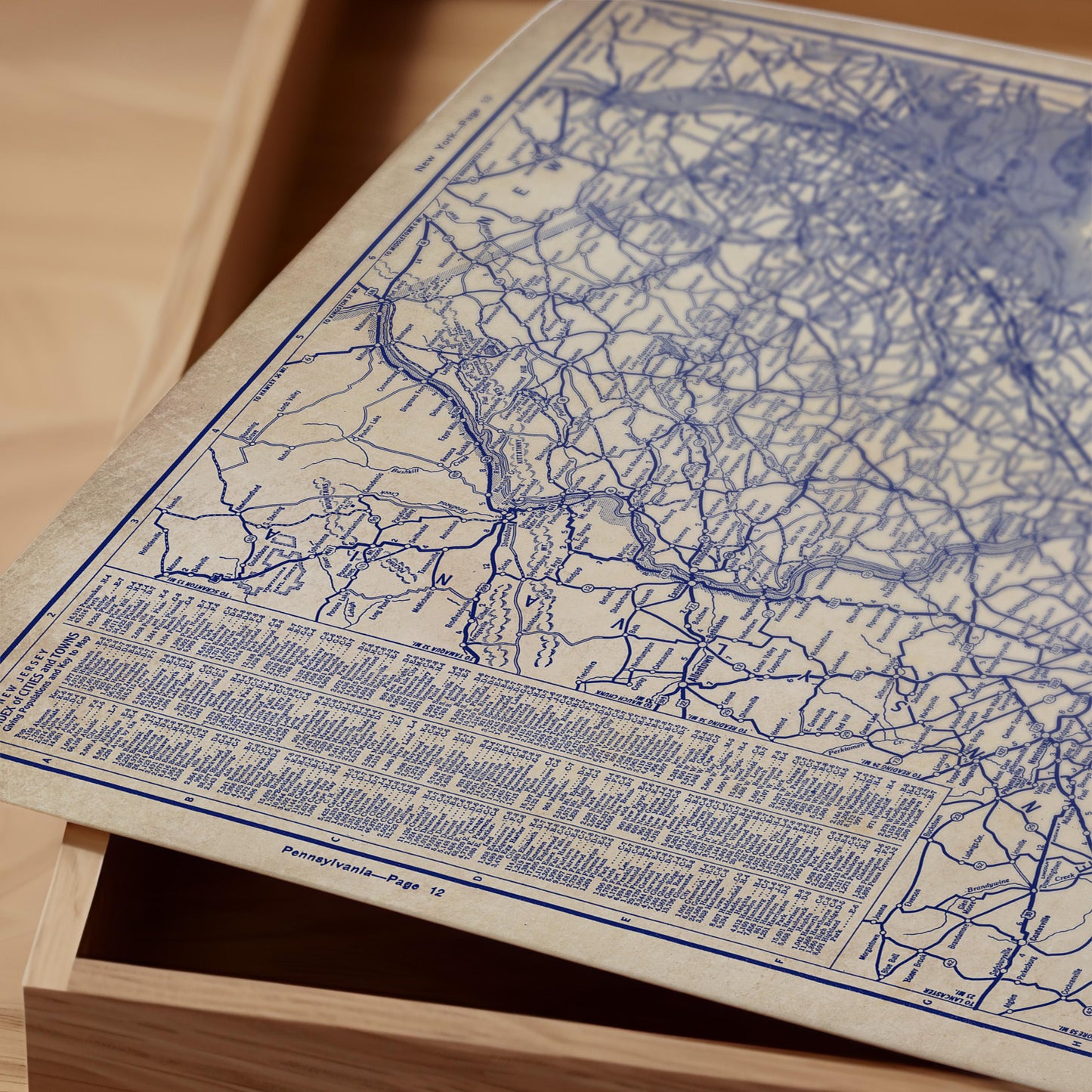 a close-up view of a map with intricate blue lines and markings, resting on a wooden surface.
