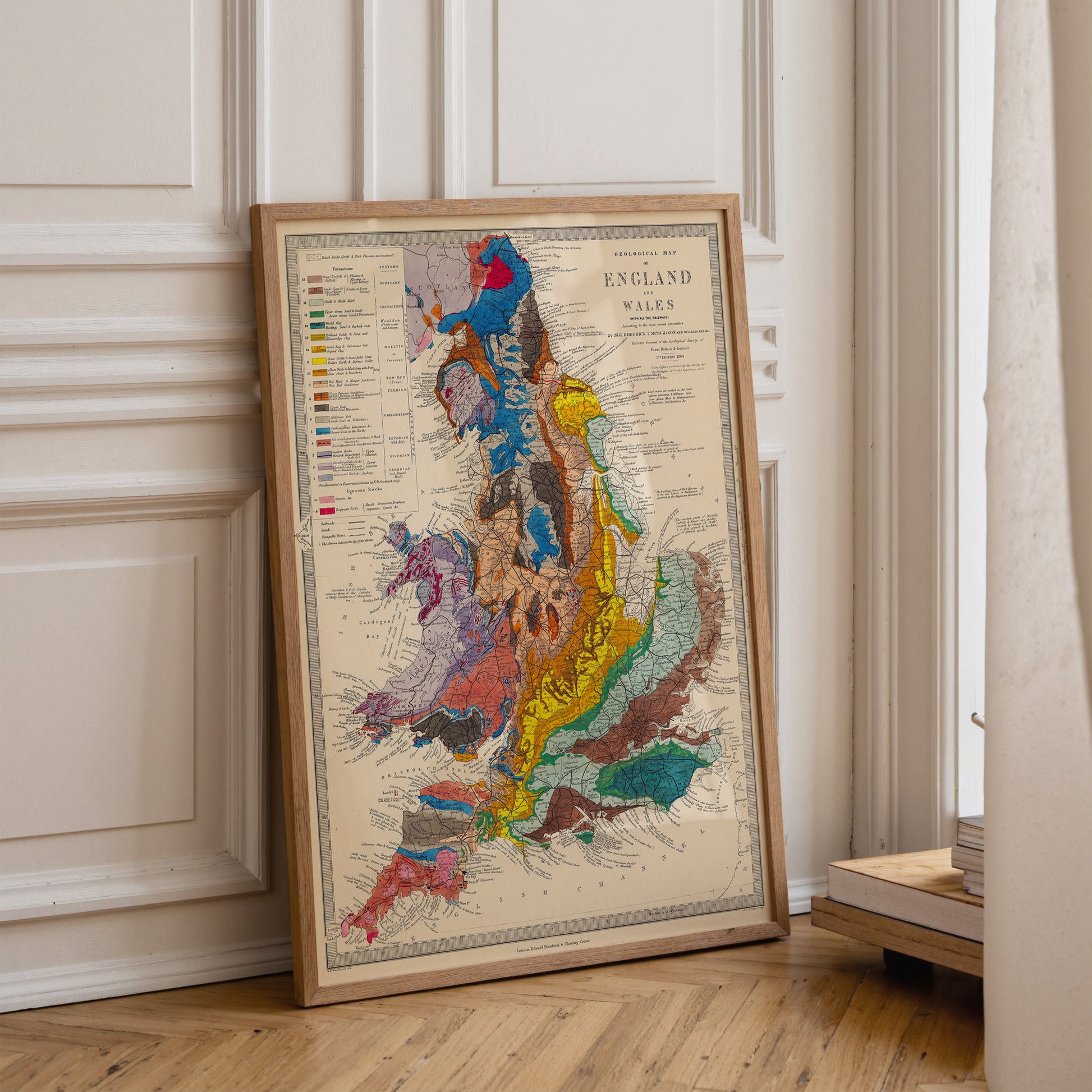 a framed geological map of England and Wales, with a detailed color-coded legend and a title that reads "GEOLOGICAL MAP OF ENGLAND & WALKS".