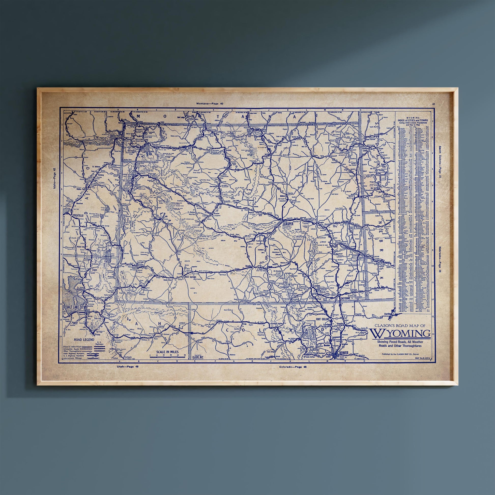 The image is a framed vintage map of Wyoming, depicting the state's roads and highways in a detailed and intricate manner.