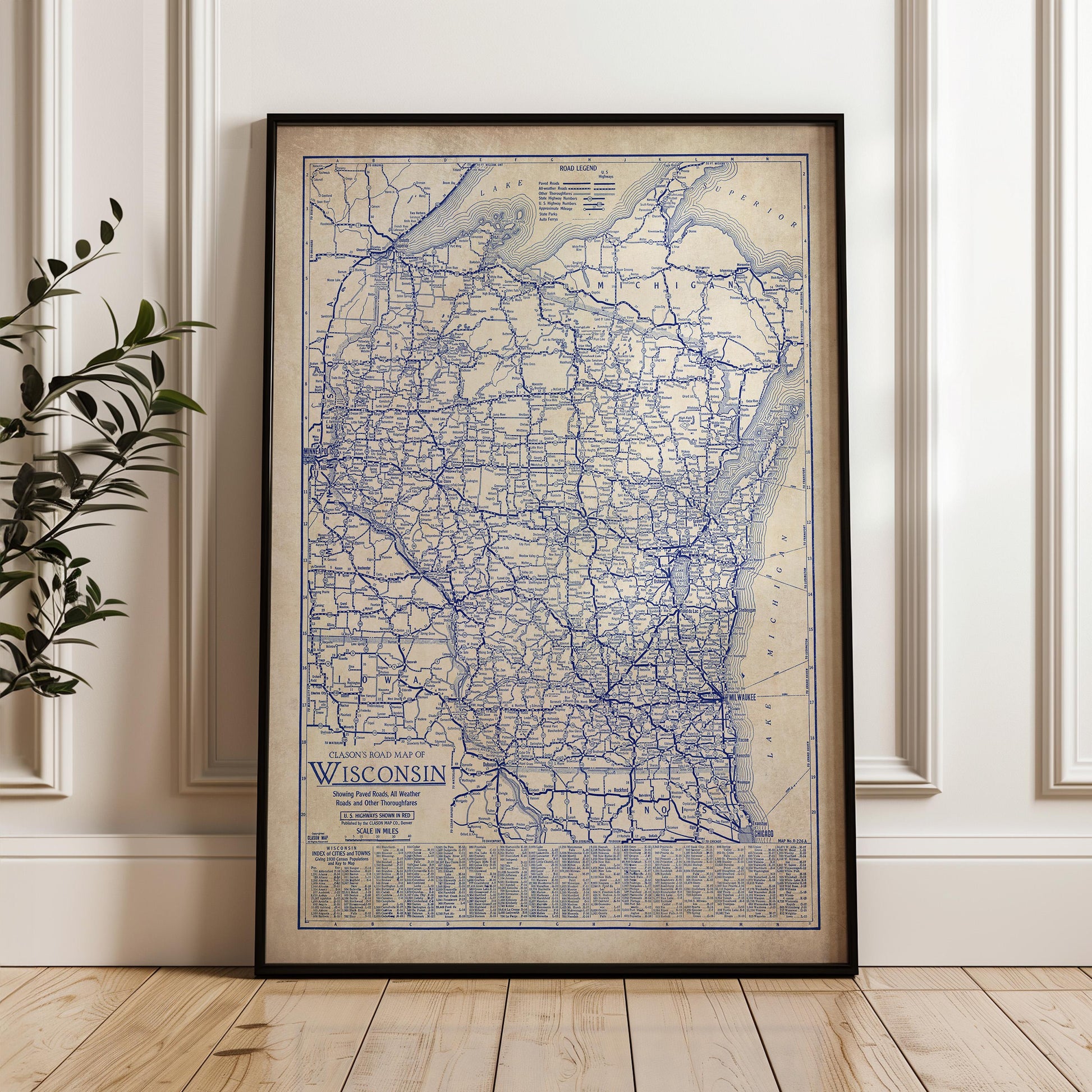 A framed vintage map of Wisconsin, showing the state's roads and highways, is displayed on a wall.