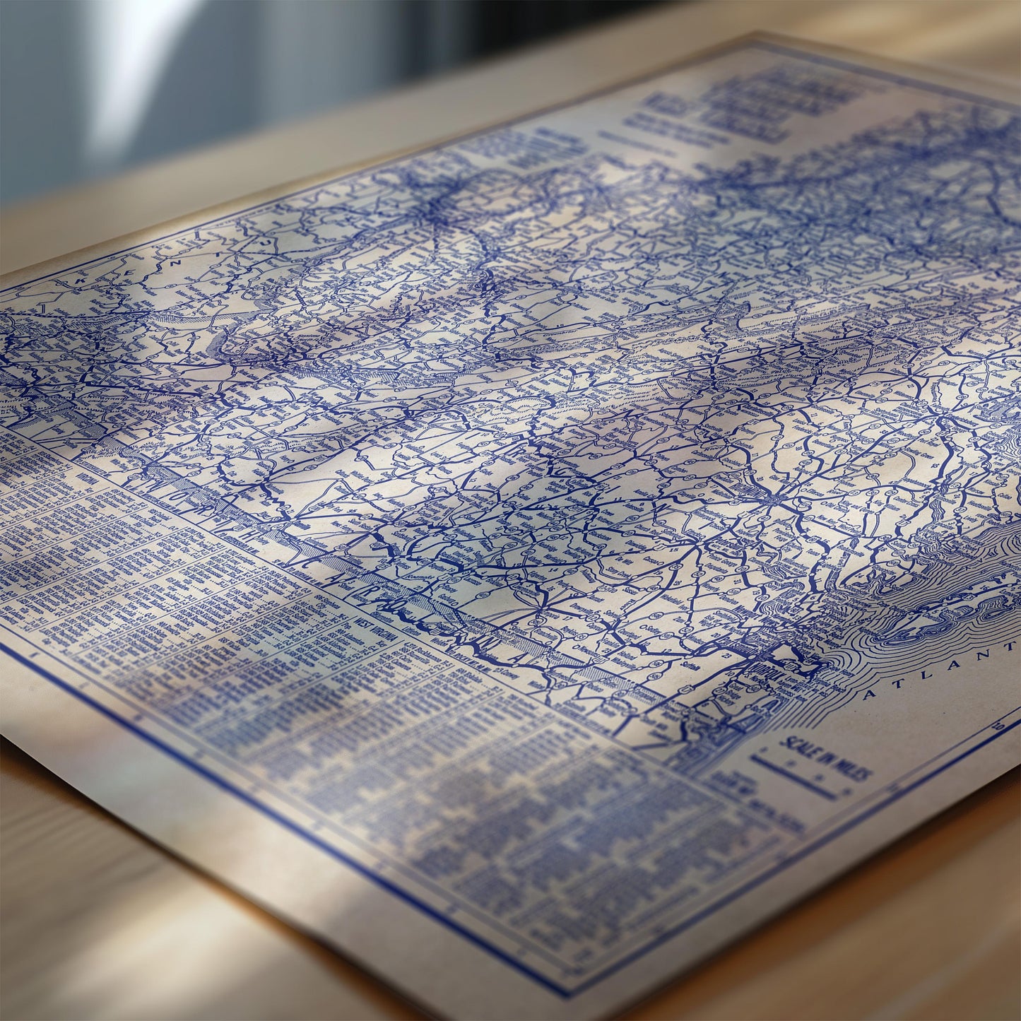 The image is a close-up of a map with intricate blue lines and markings, resting on a wooden surface.