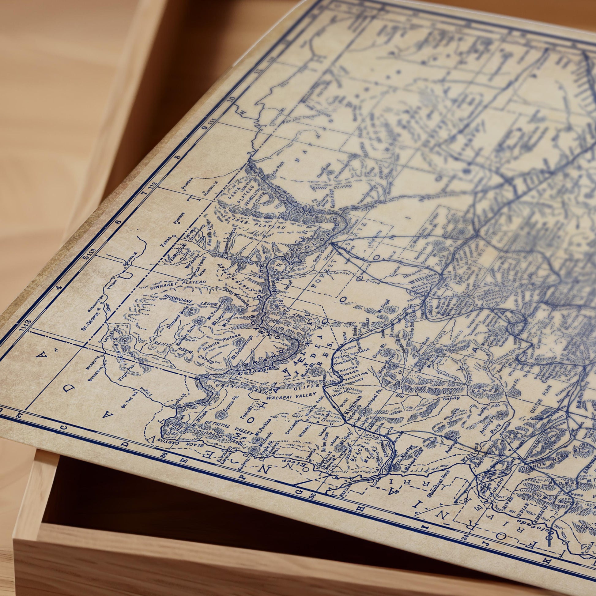a close-up view of an old map with intricate details and markings, resting on a wooden surface.
