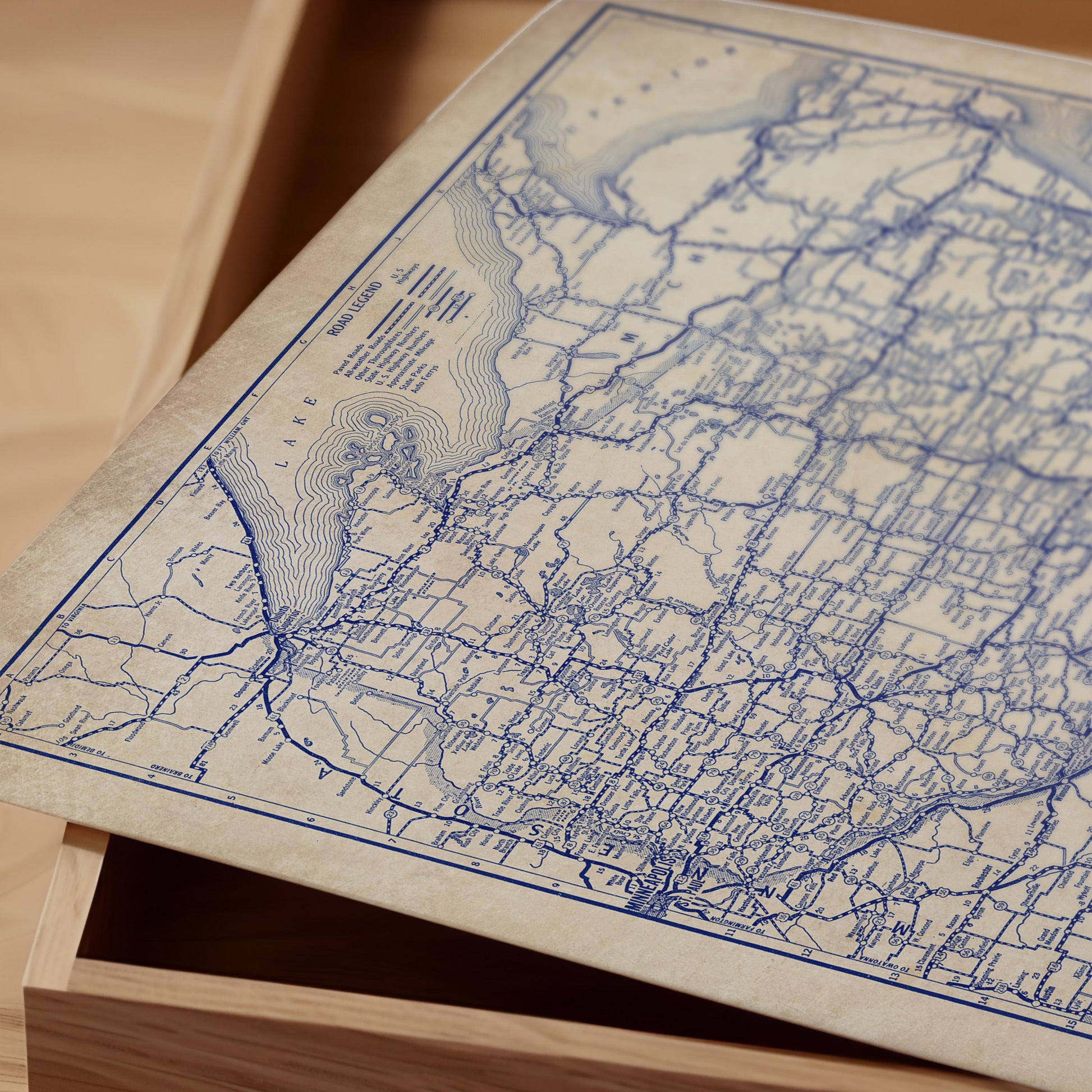 a close-up view of a vintage map of the United States, with intricate blue lines and markings representing roads and geographical features.