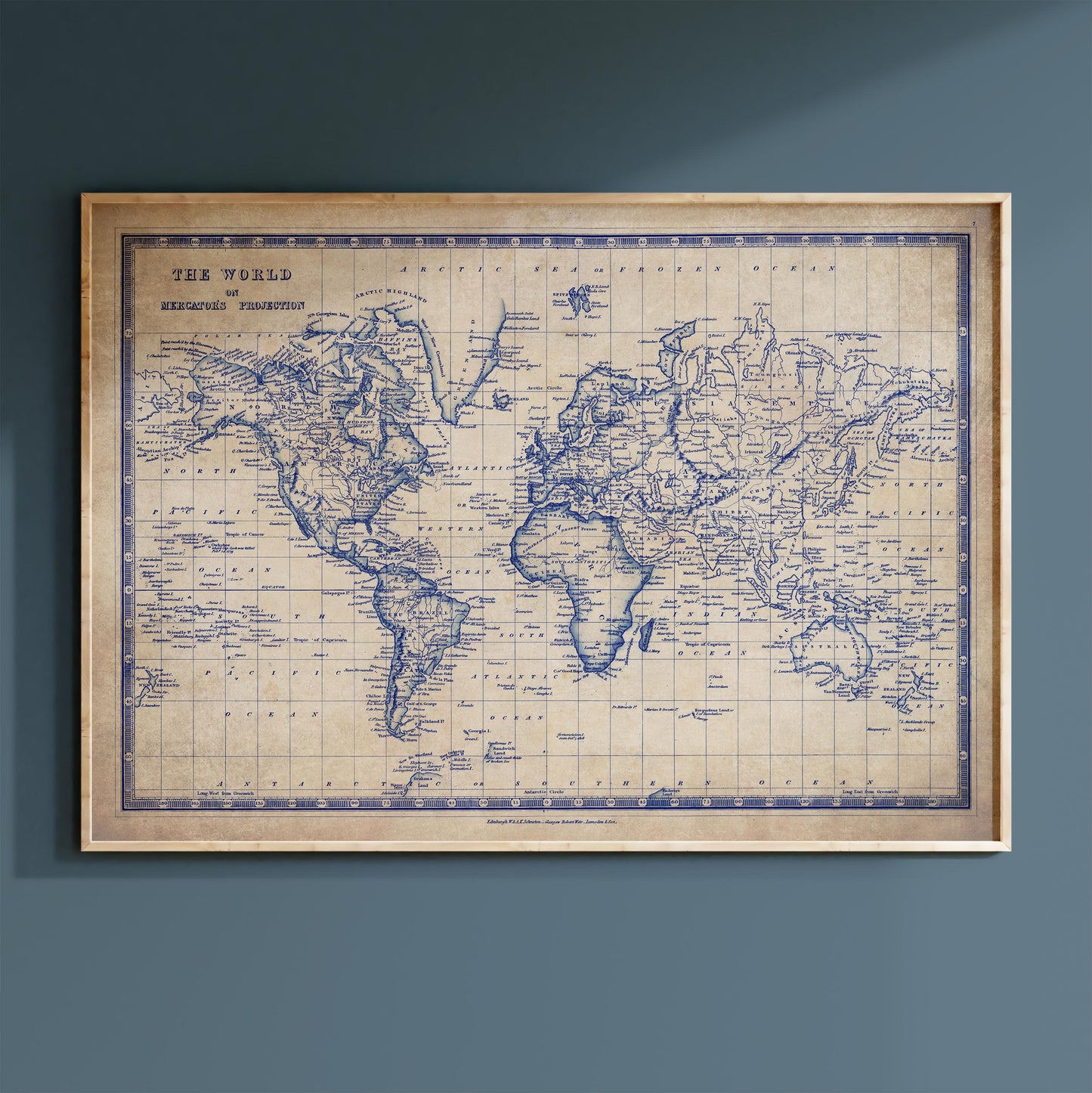 The image is a vintage world map with a blue and white color scheme, displayed on a wall.