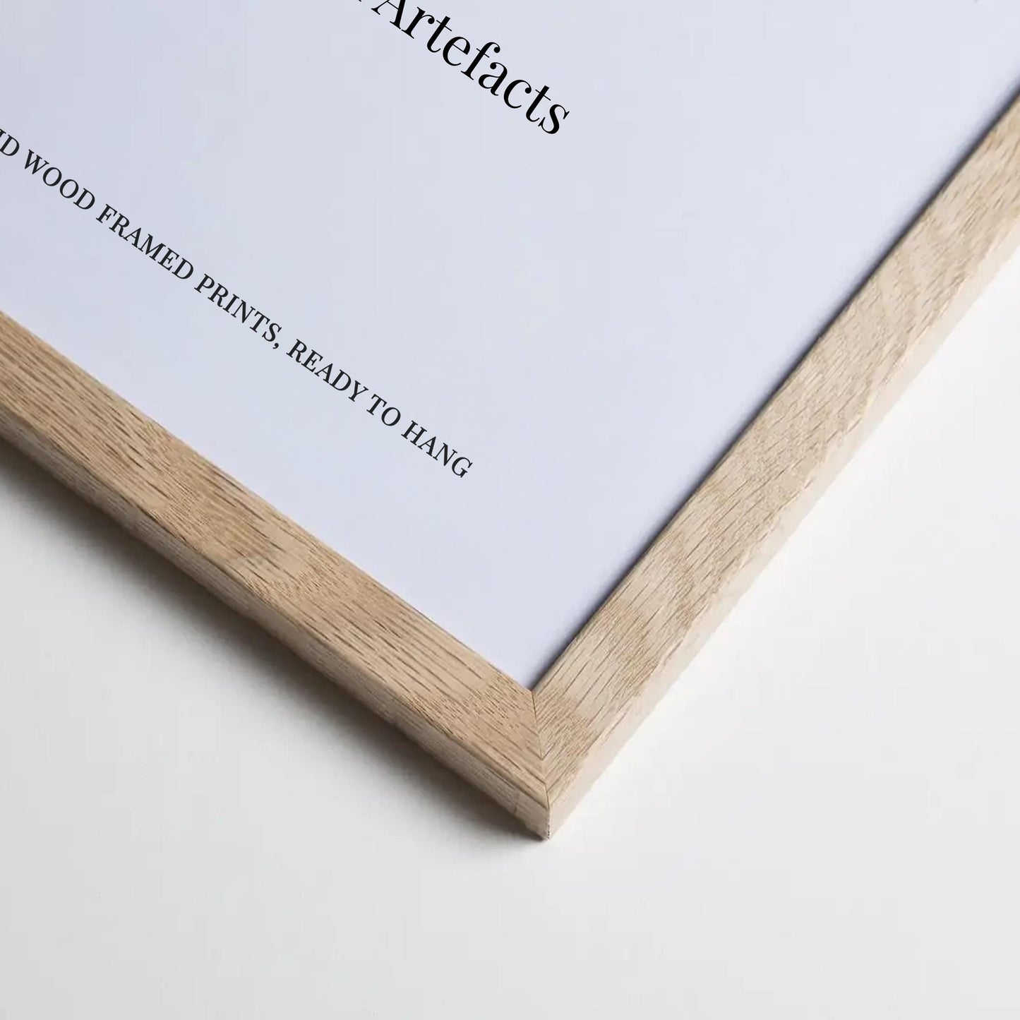 a close-up view of a wooden-framed print on a white background.