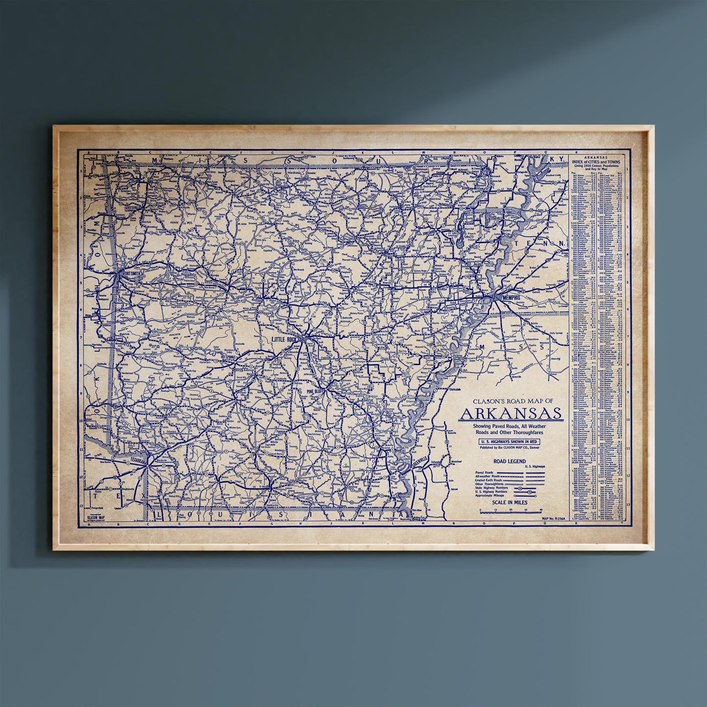 The image is a framed vintage map of Arkansas, showing the state's roads and highways in a detailed and intricate manner.