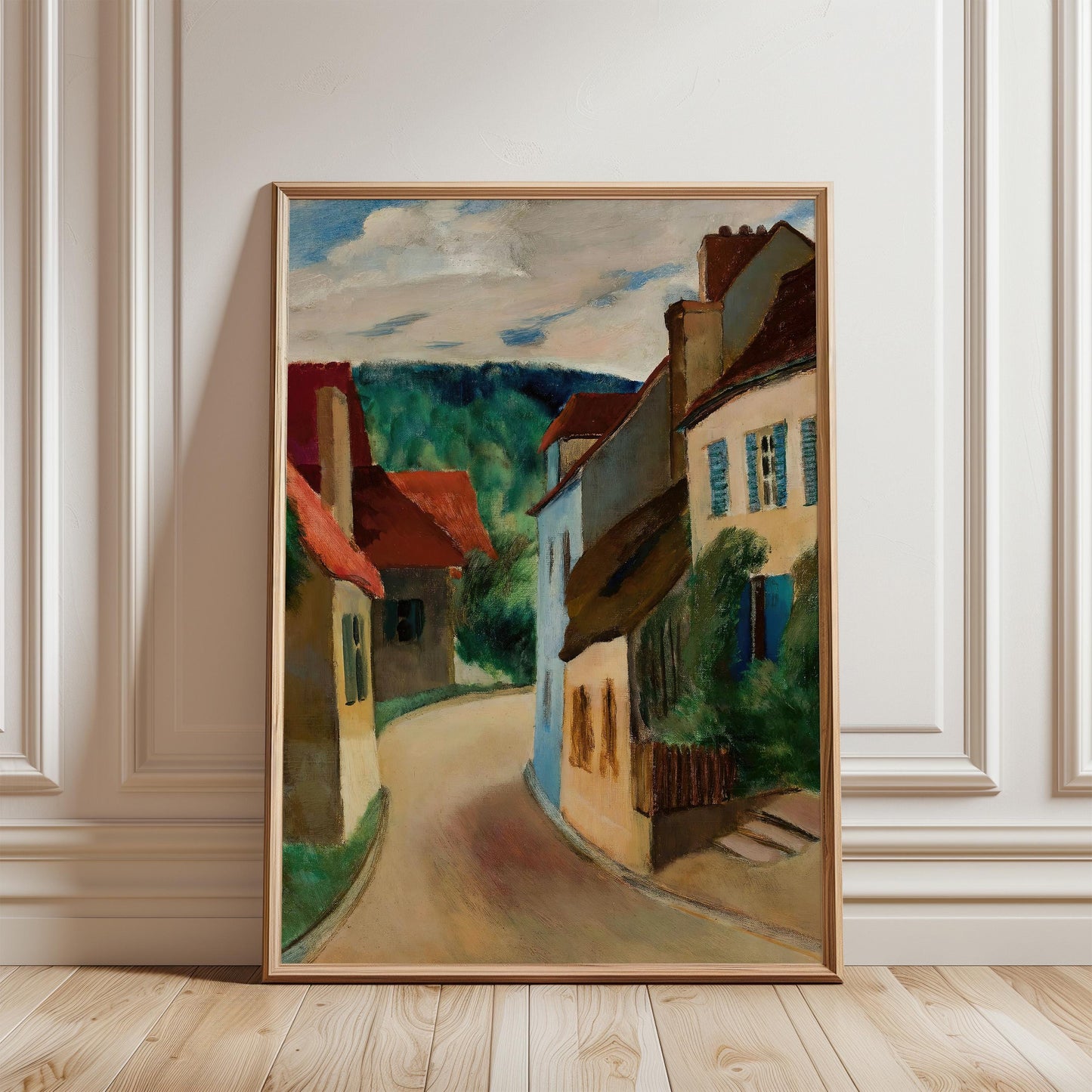 The image is a framed painting depicting a picturesque street scene with colorful buildings, a winding road, and a cloudy sky.