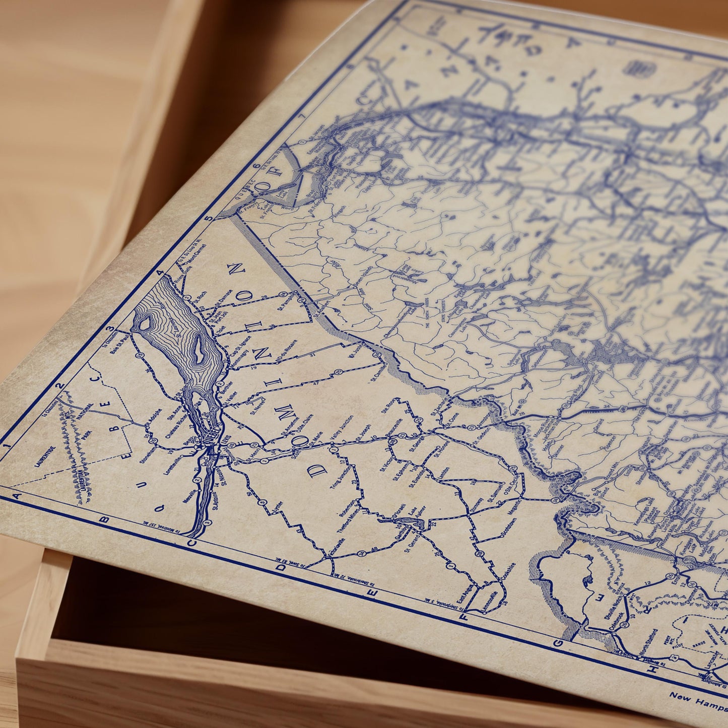 a close-up view of a map with intricate blue lines and markings, resting on a wooden surface.