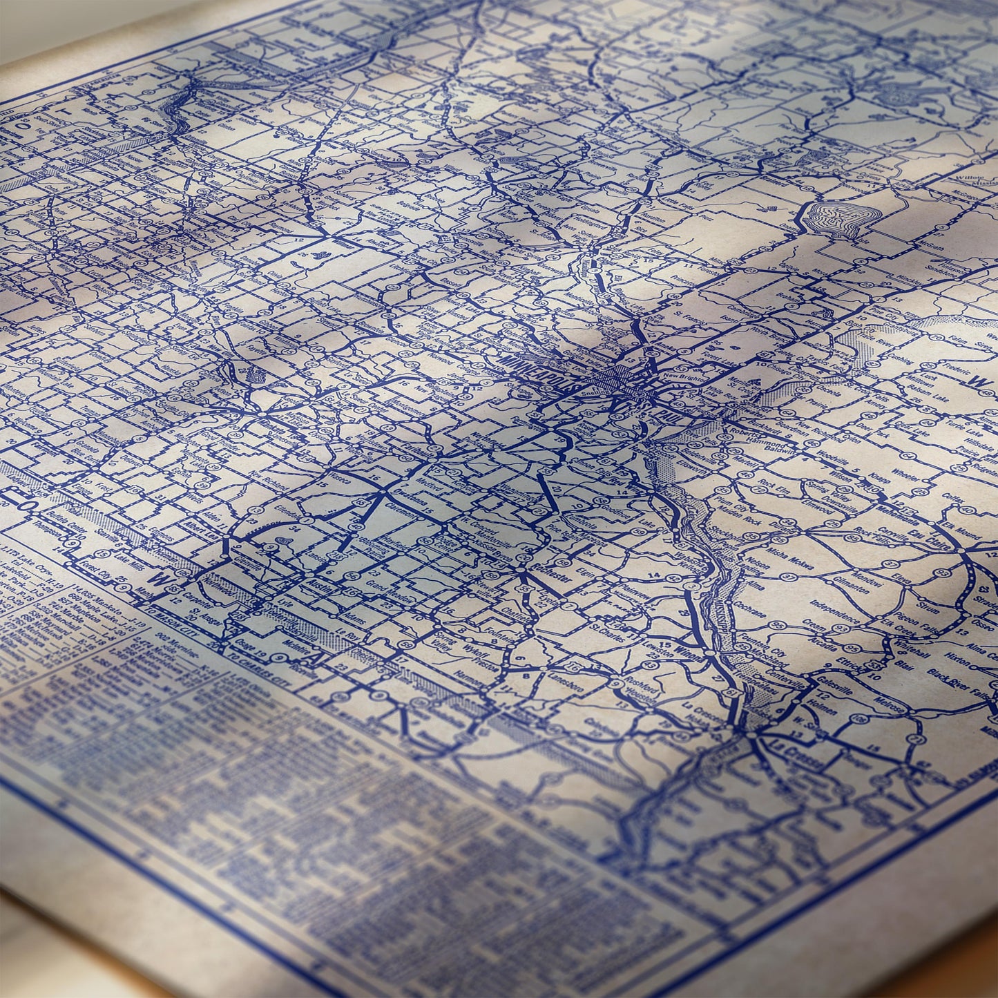 The image is a detailed map of a region, with various roads and landmarks depicted in blue and white. The map appears to be a vintage or historical document, as indicated by the intricate lines and patterns.