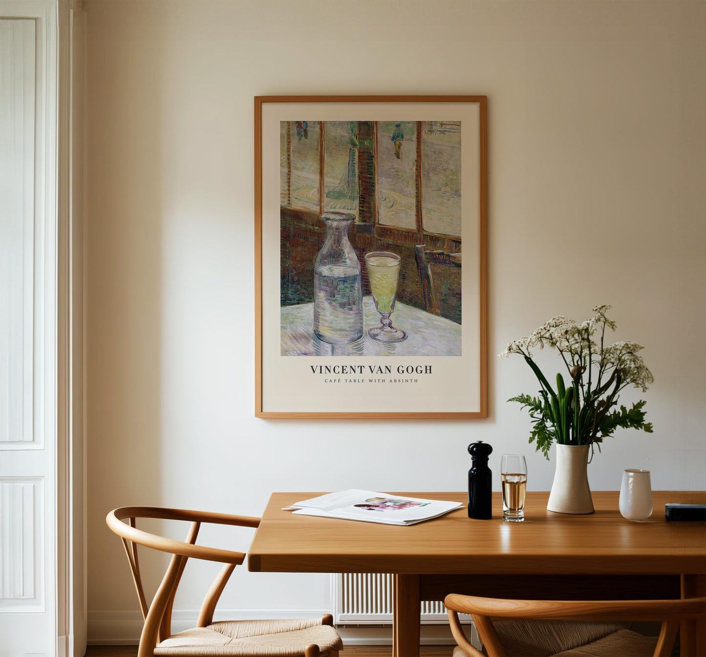 a framed painting of two wine glasses on a table, with a vase of flowers and a newspaper on the table.