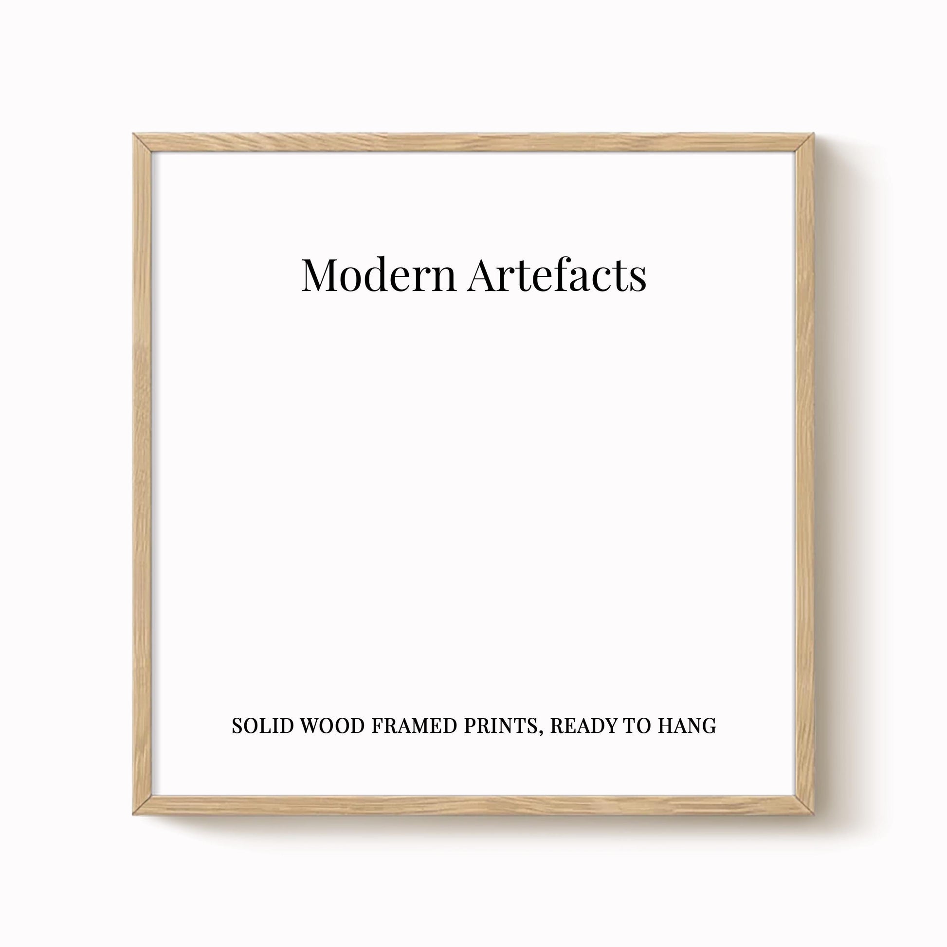 The image is a square-shaped white frame with the text "Modern Artifacts" written in black at the top. Below the frame, the text reads "SOLID WOOD FRAMED PRINTS. READY TO HANG".
