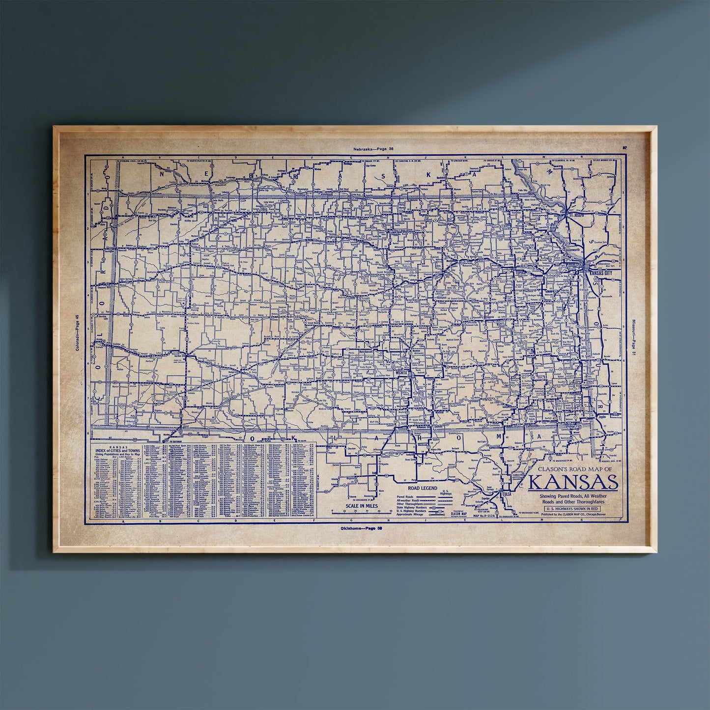 The image is a framed vintage map of Kansas, showing the state's roads and highways in a detailed and intricate manner.