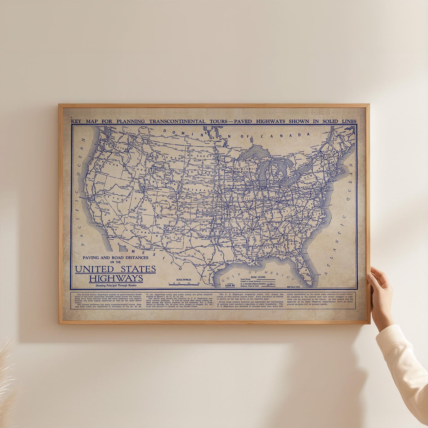 A framed vintage map of the United States, showing the paved and non-paved highways, is displayed on a wall.