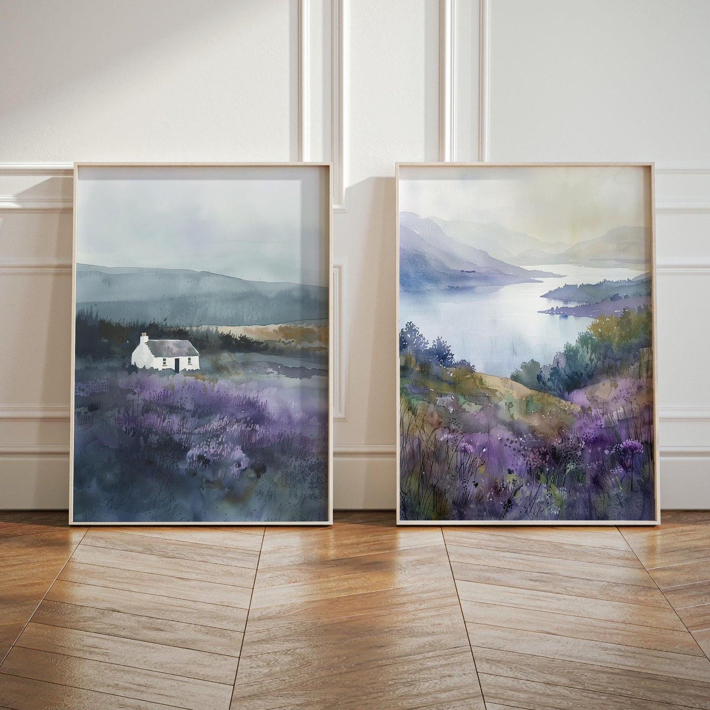two framed watercolor paintings of a serene landscape, featuring a small white house nestled in a field of purple flowers.