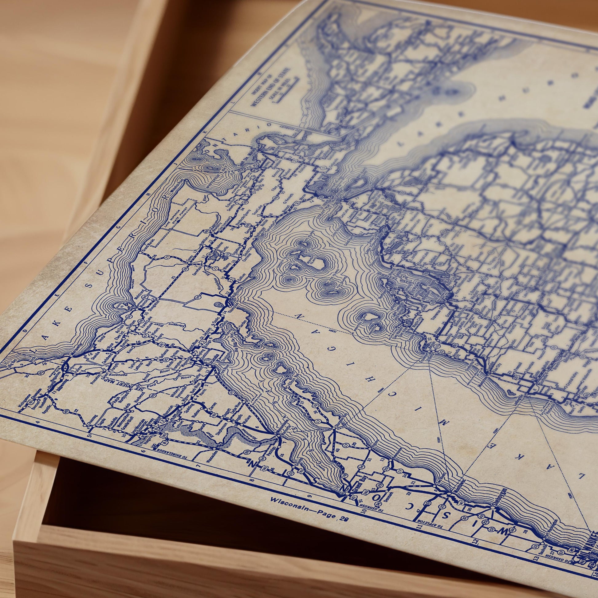 a close-up view of a vintage map of the United States, with intricate blue lines and markings representing geographical features and boundaries.