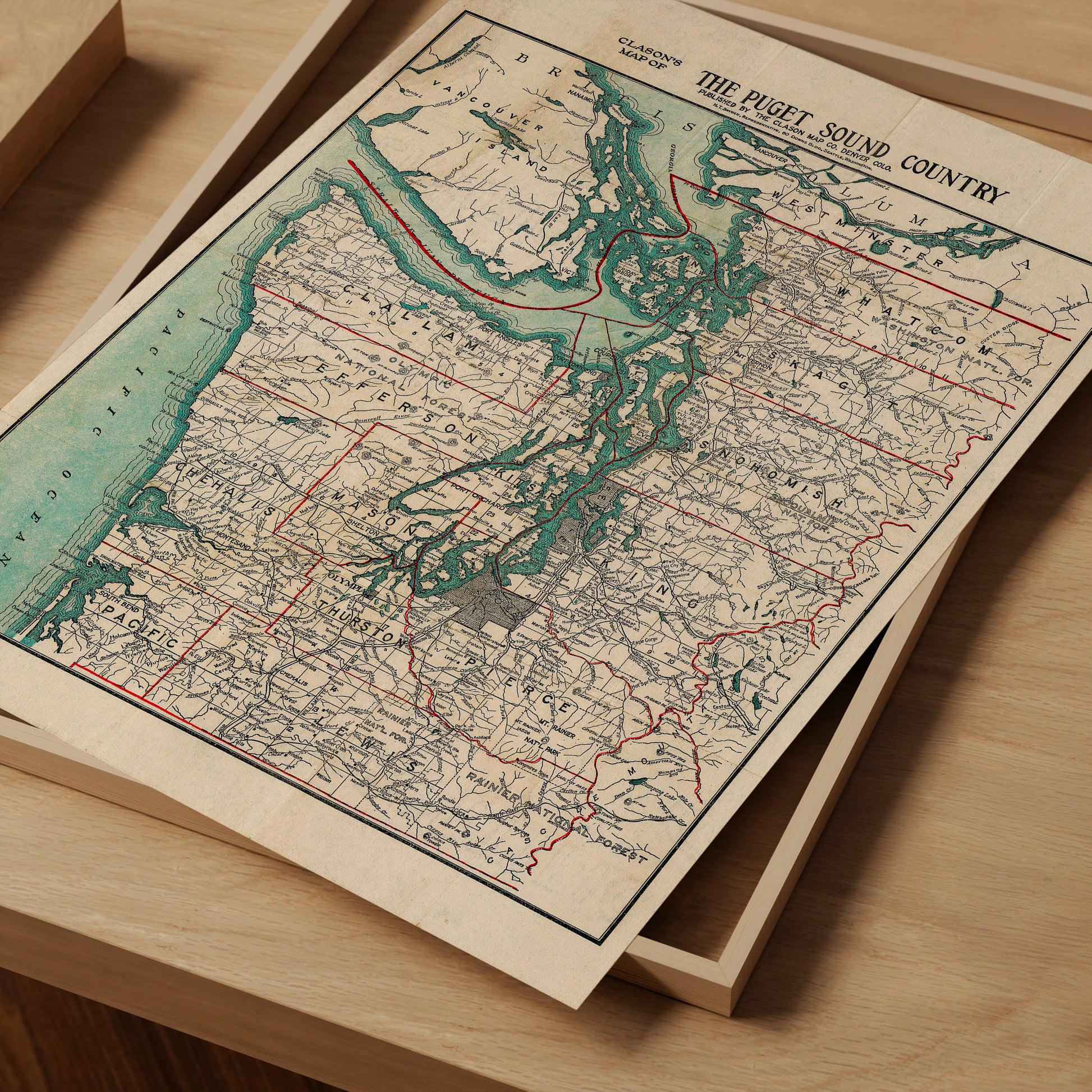 The image is a vintage map of the Puget Sound Country, depicting the region in a detailed and intricate manner.