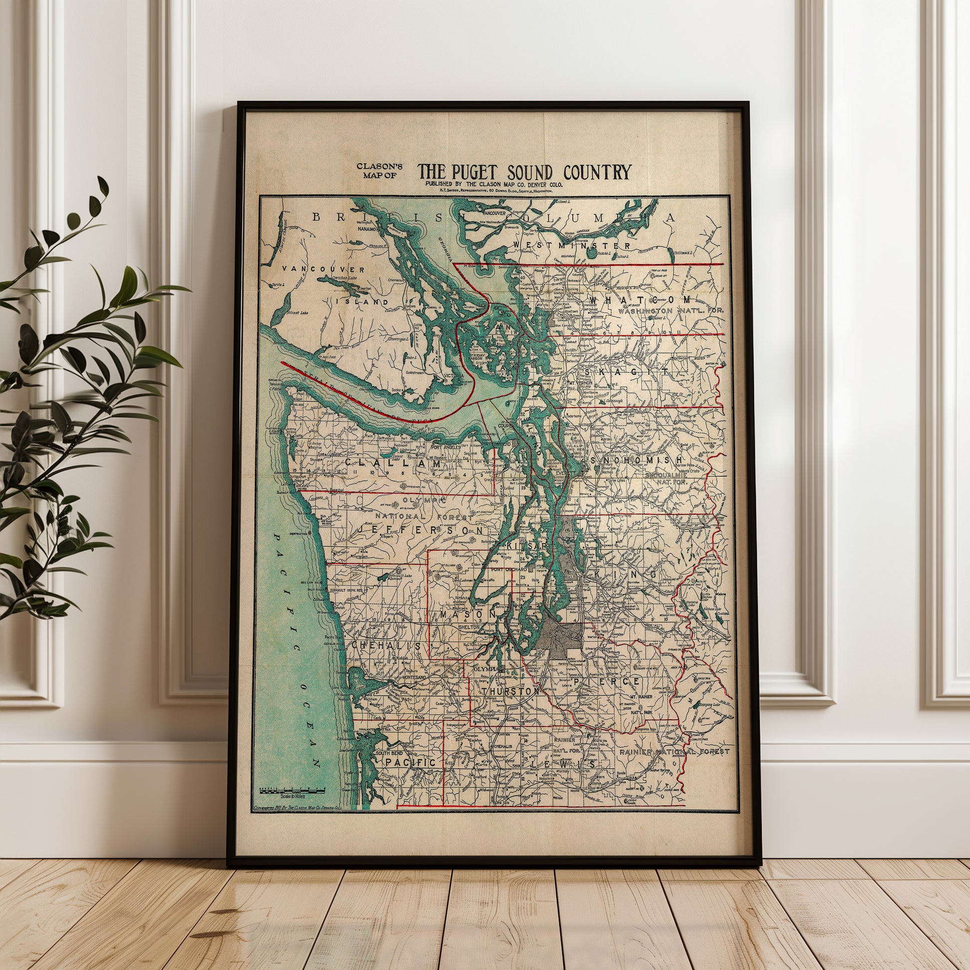The image is a framed vintage map of the Puget Sound Country, depicting the region in a detailed and colorful manner.