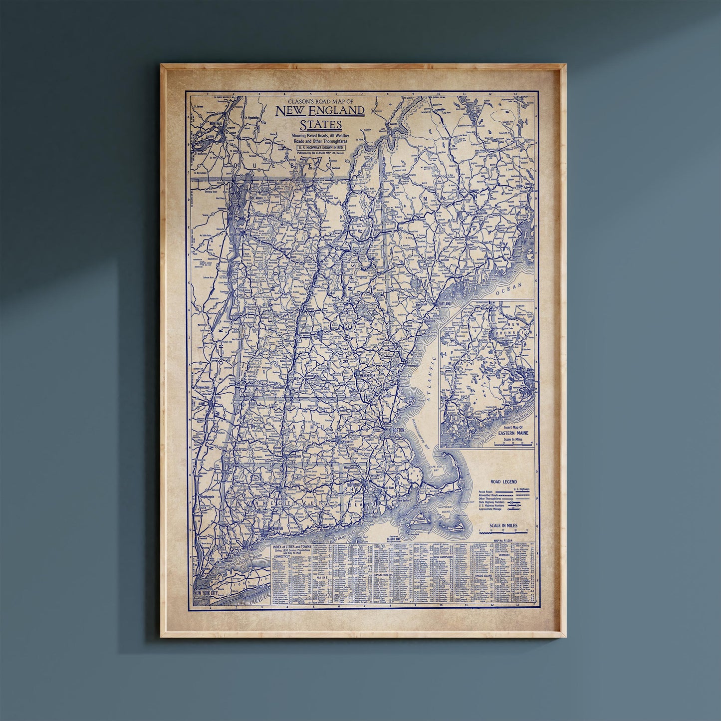The image is a framed vintage map of the New England region of the United States, depicting the area in a detailed and intricate manner.