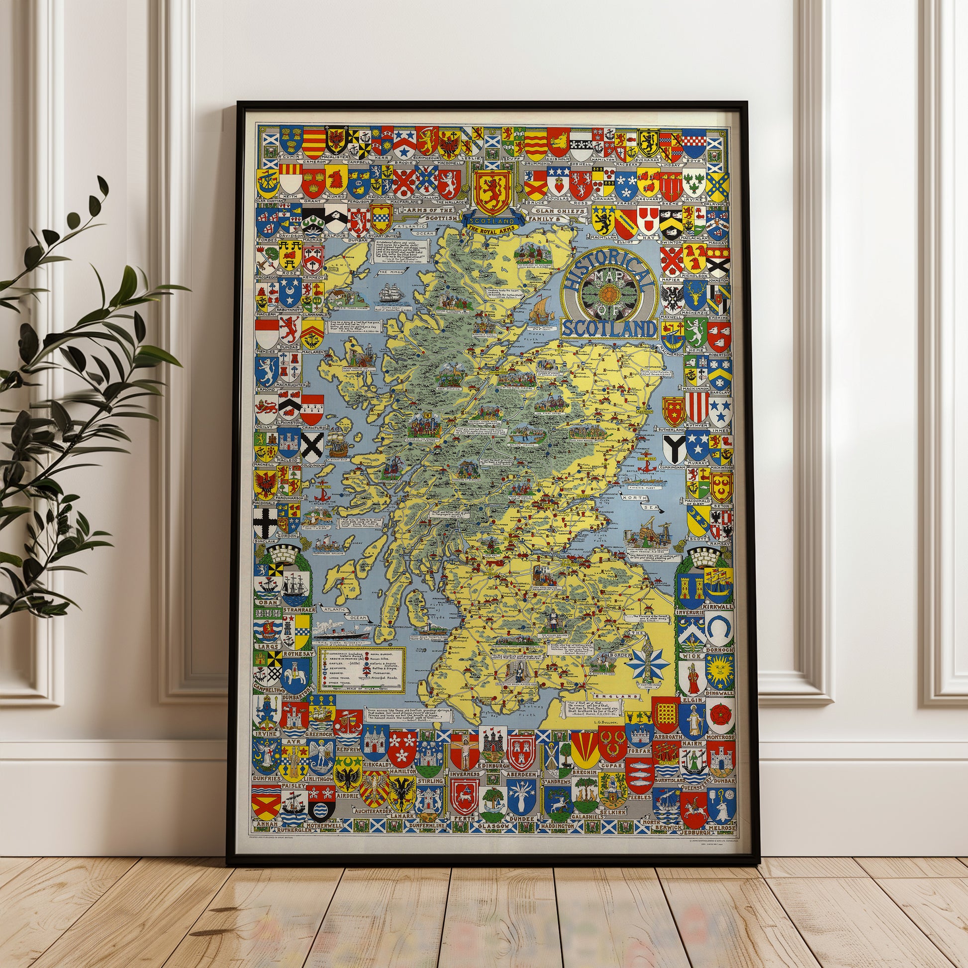 The image is a framed map of Scotland, featuring various national symbols and coat of arms from different regions of the country.
