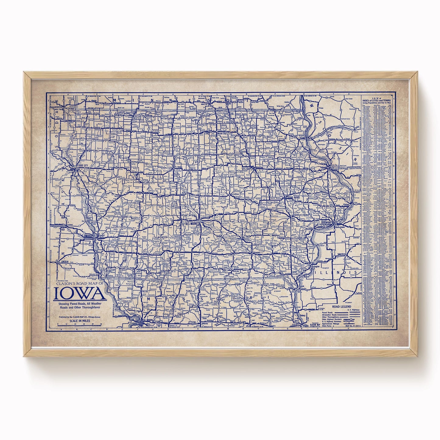 The image is a framed vintage map of Iowa, showing the state's roads and highways in a detailed and intricate manner.
