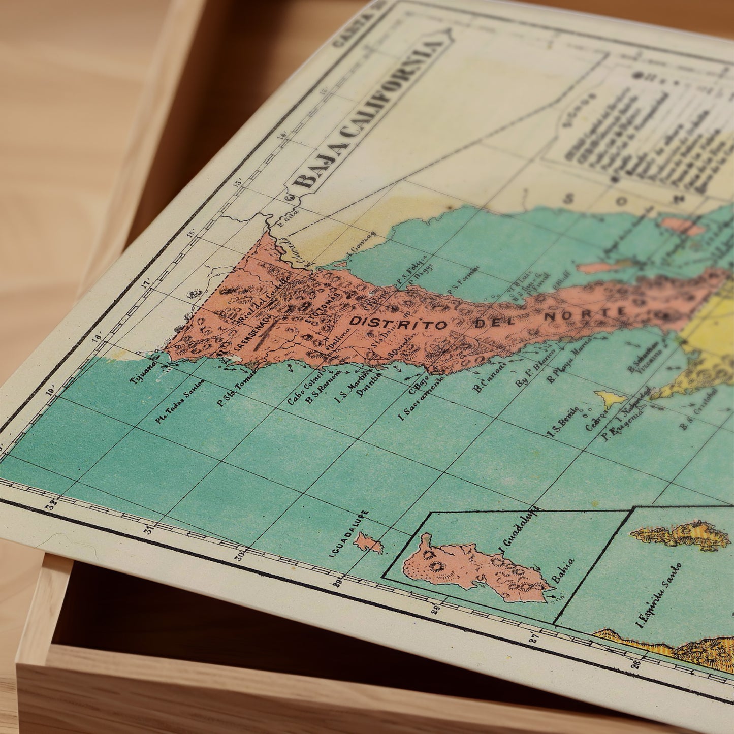 The image is a vintage map of the Baja California region, featuring a colorful and detailed depiction of the area.