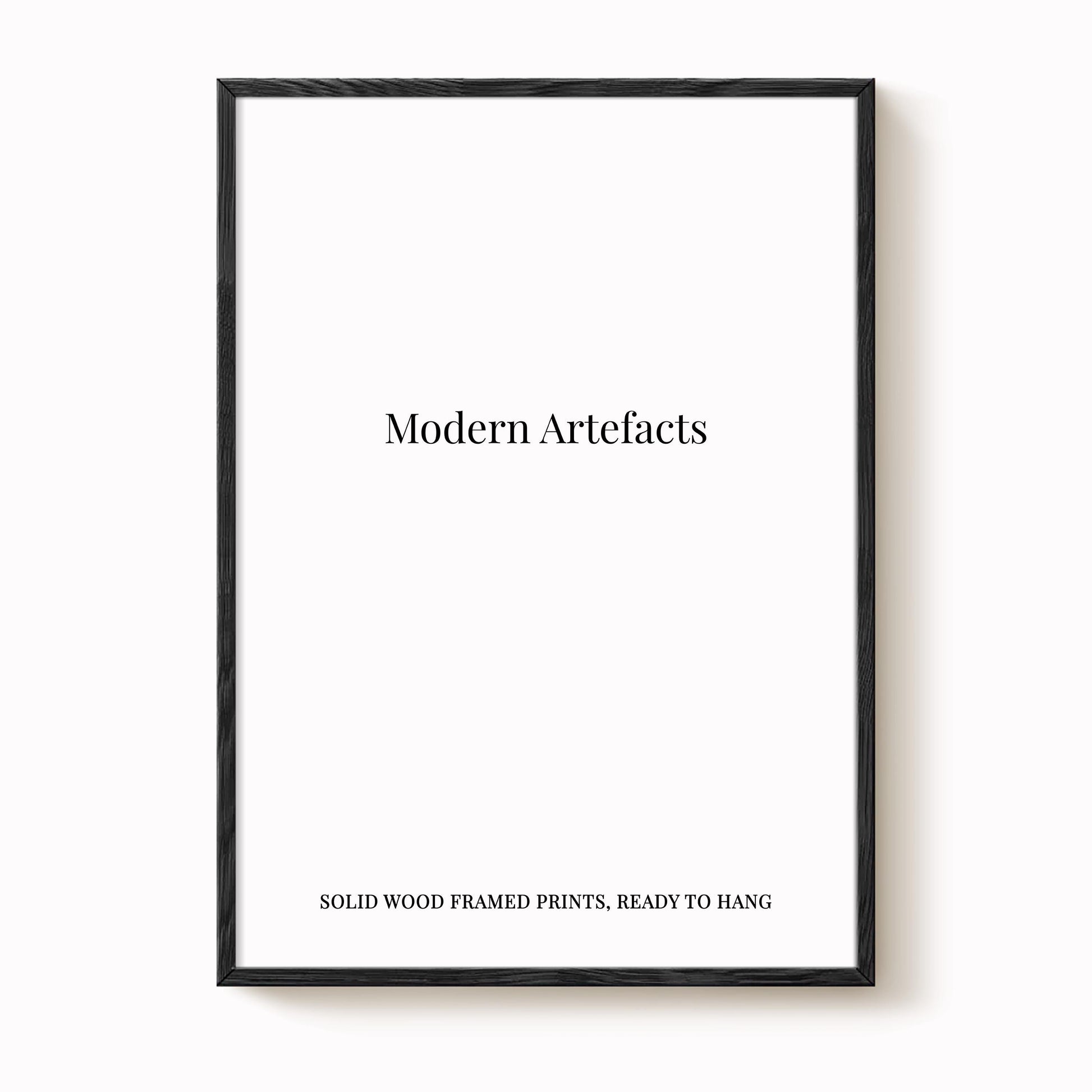The image is a black framed print with the text "Modern Artifacts" and "SOLIDWOOD FRAMED PRINTS, READY TO HANG" printed on it.